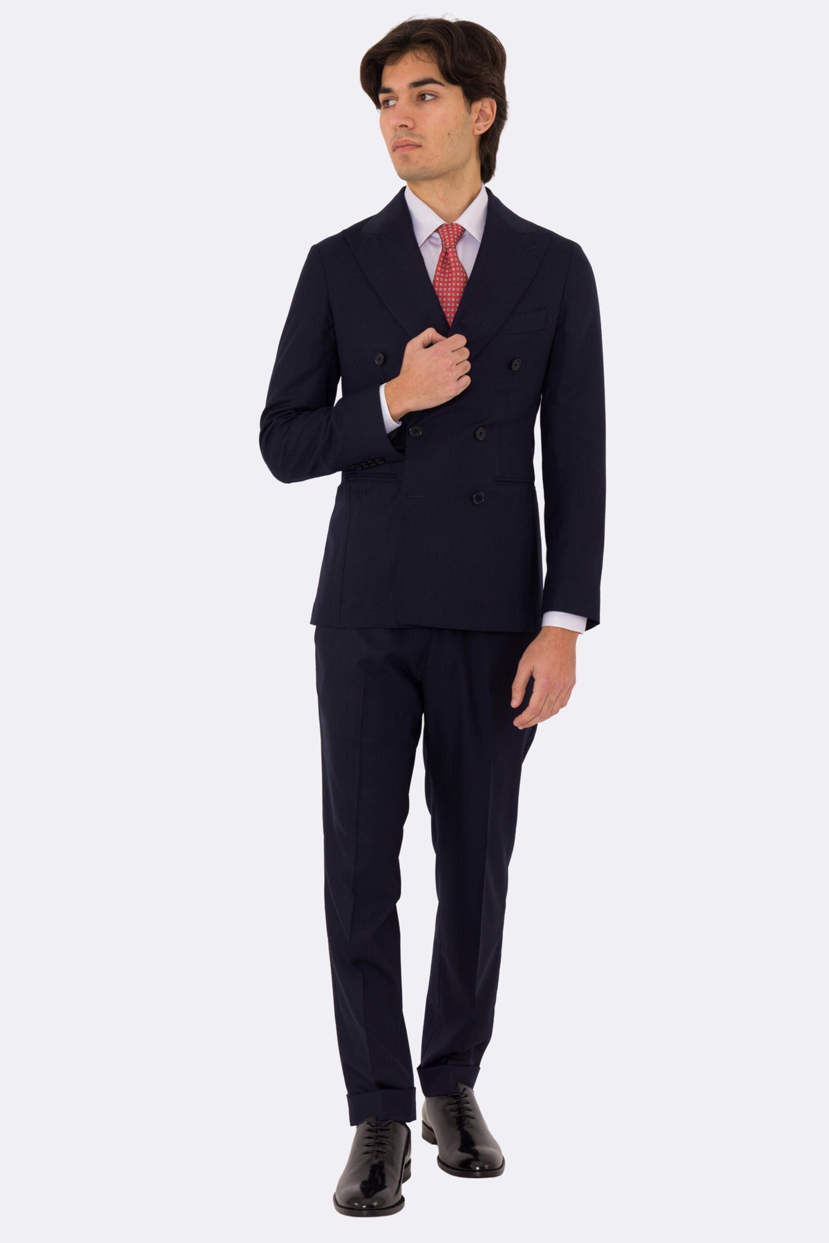 Abito uomo Doppiopetto Blu spigato fresco lana super 150's Tessuti in esclusiva Sartoria Carillo completamente sfoderato con Rever a lancia e tasche a filetto .
