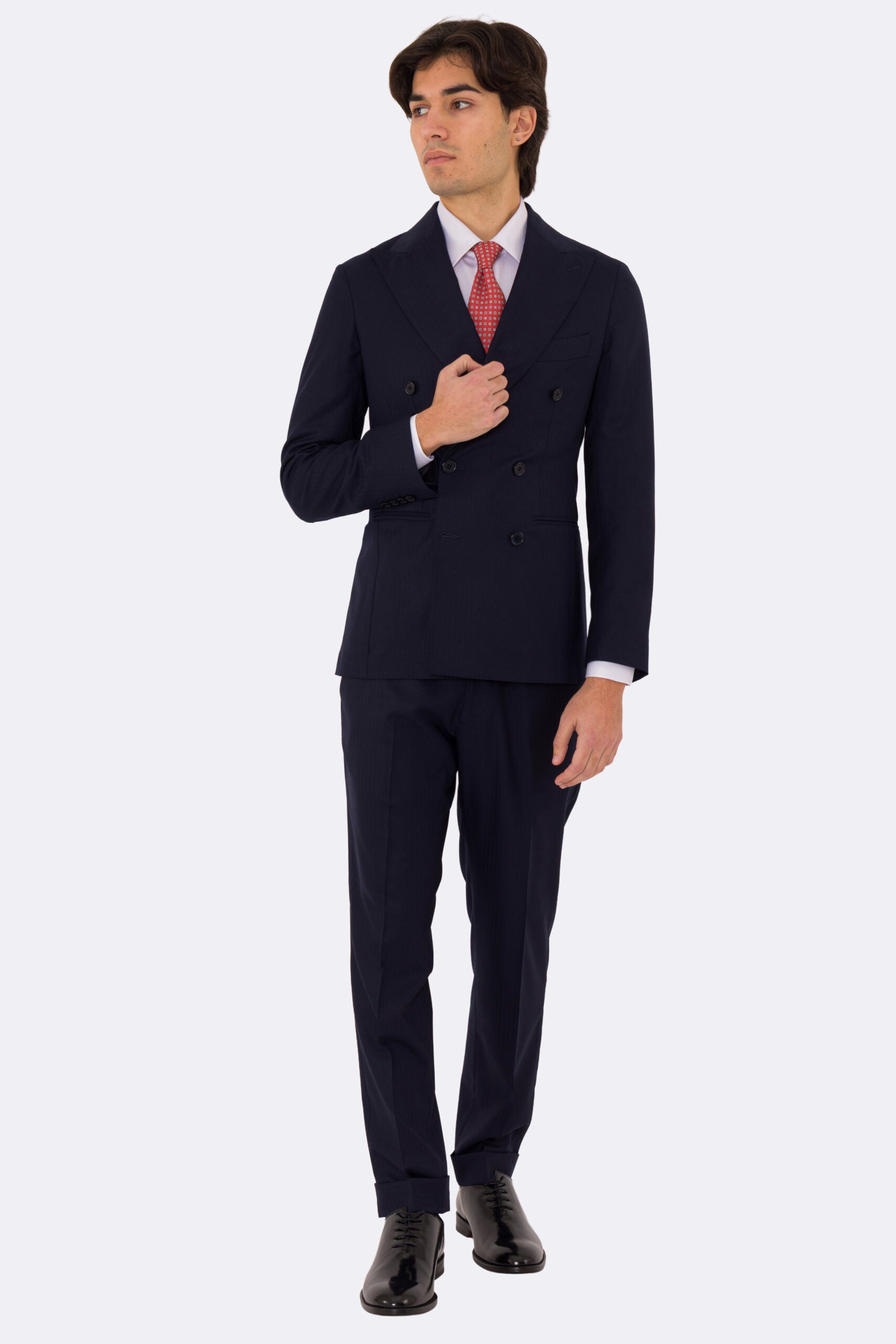 Abito uomo Doppiopetto Blu spigato fresco lana super 150's Tessuti in esclusiva Sartoria Carillo completamente sfoderato con Rever a lancia e tasche a filetto .